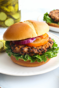 sweet potato black bean burger served on a bun with lettuce and tomato.