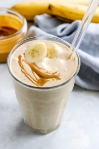 peanut butter banana smoothie with banana slice on top
