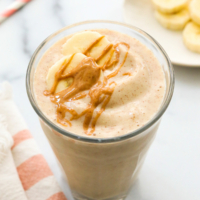 peanut butter banana smoothie topped with peanut butter drizzle.