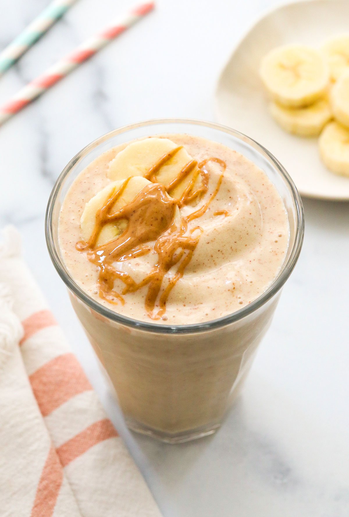 peanut butter banana smoothie topped with peanut butter drizzle. 
