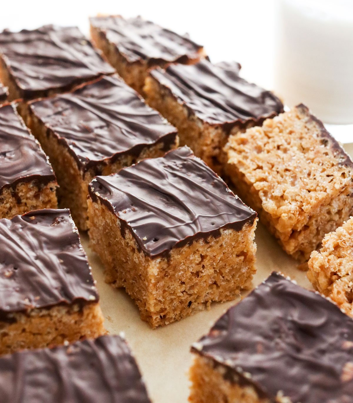 peanut butter rice crispy treats topped with chocolate.