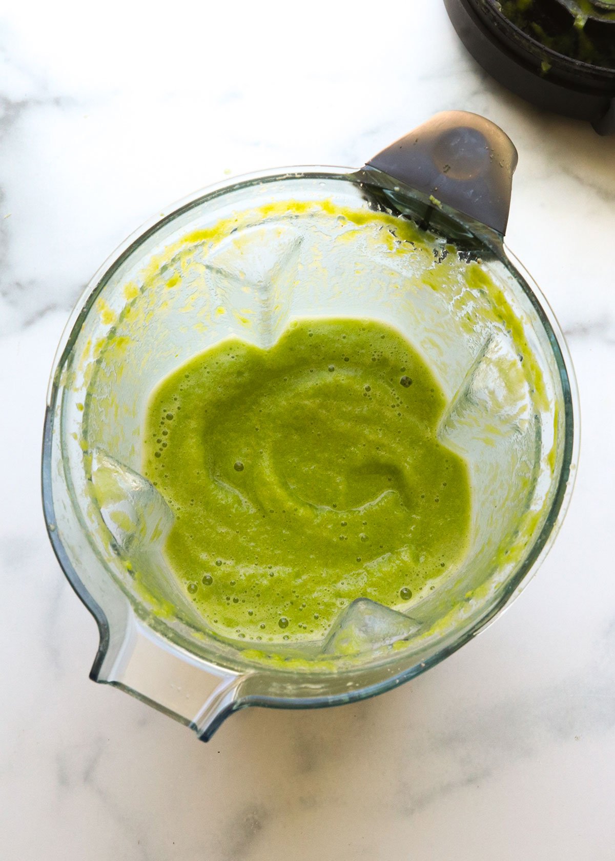 green detox smoothie blended until smooth in the pitcher.