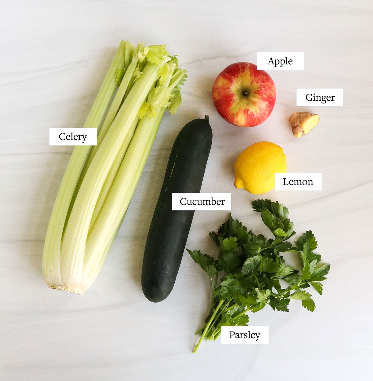 detox juice ingredients labeled on a white surface.