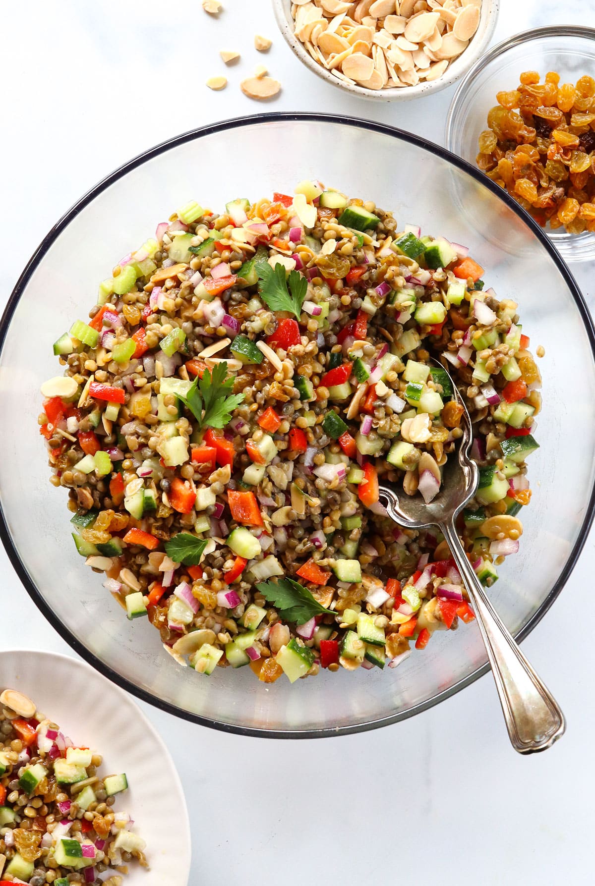 Lentil salad mixed together in a large glass bowl.
