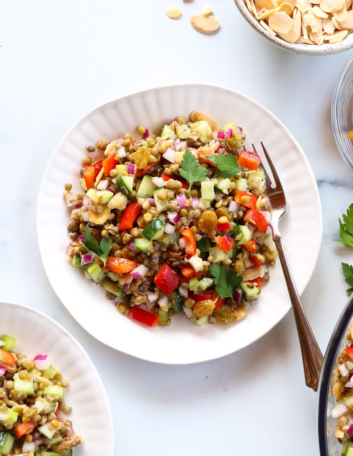 Lentil salad recipe served on two white plates with a fork.