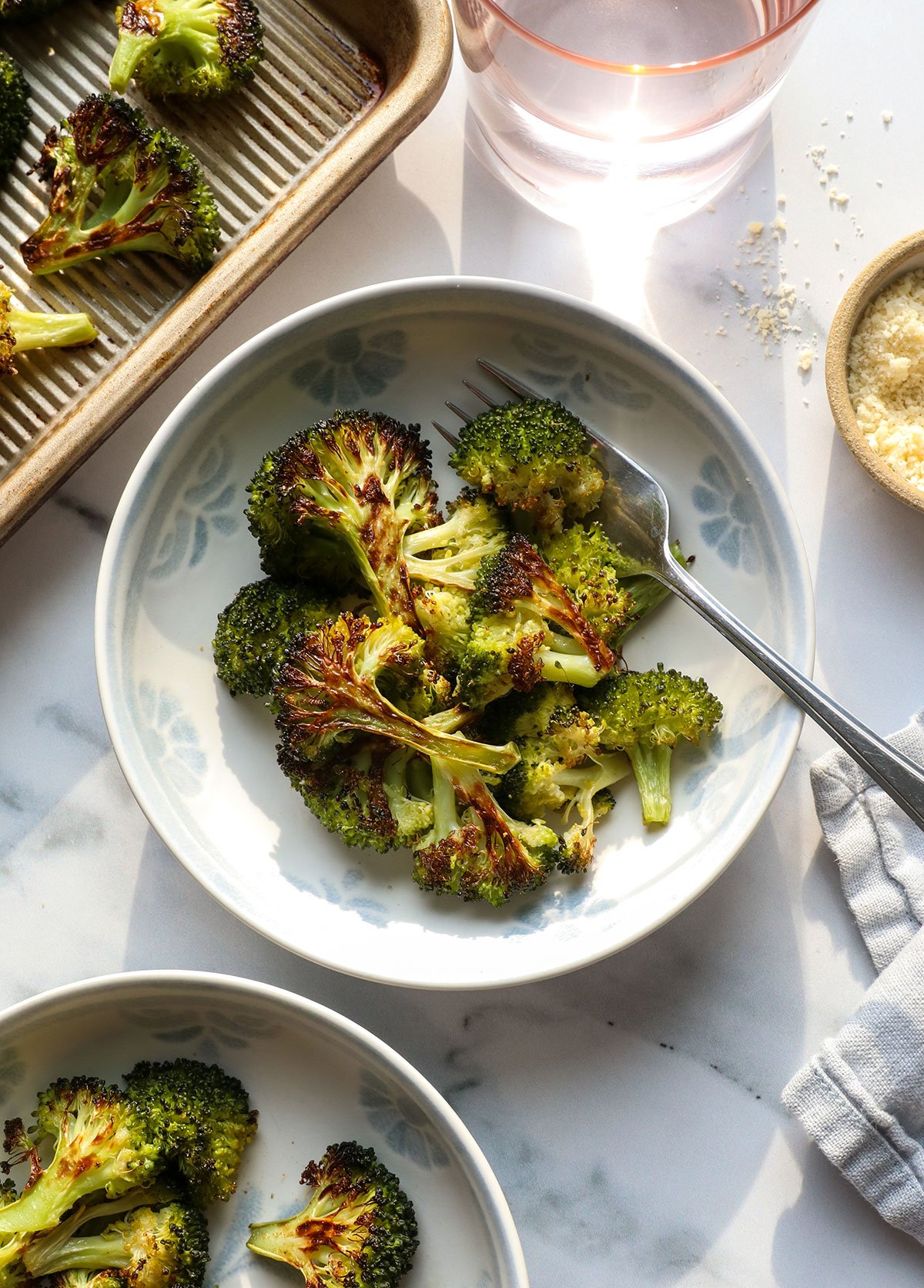 roasted broccoli in a bowl with a fork.