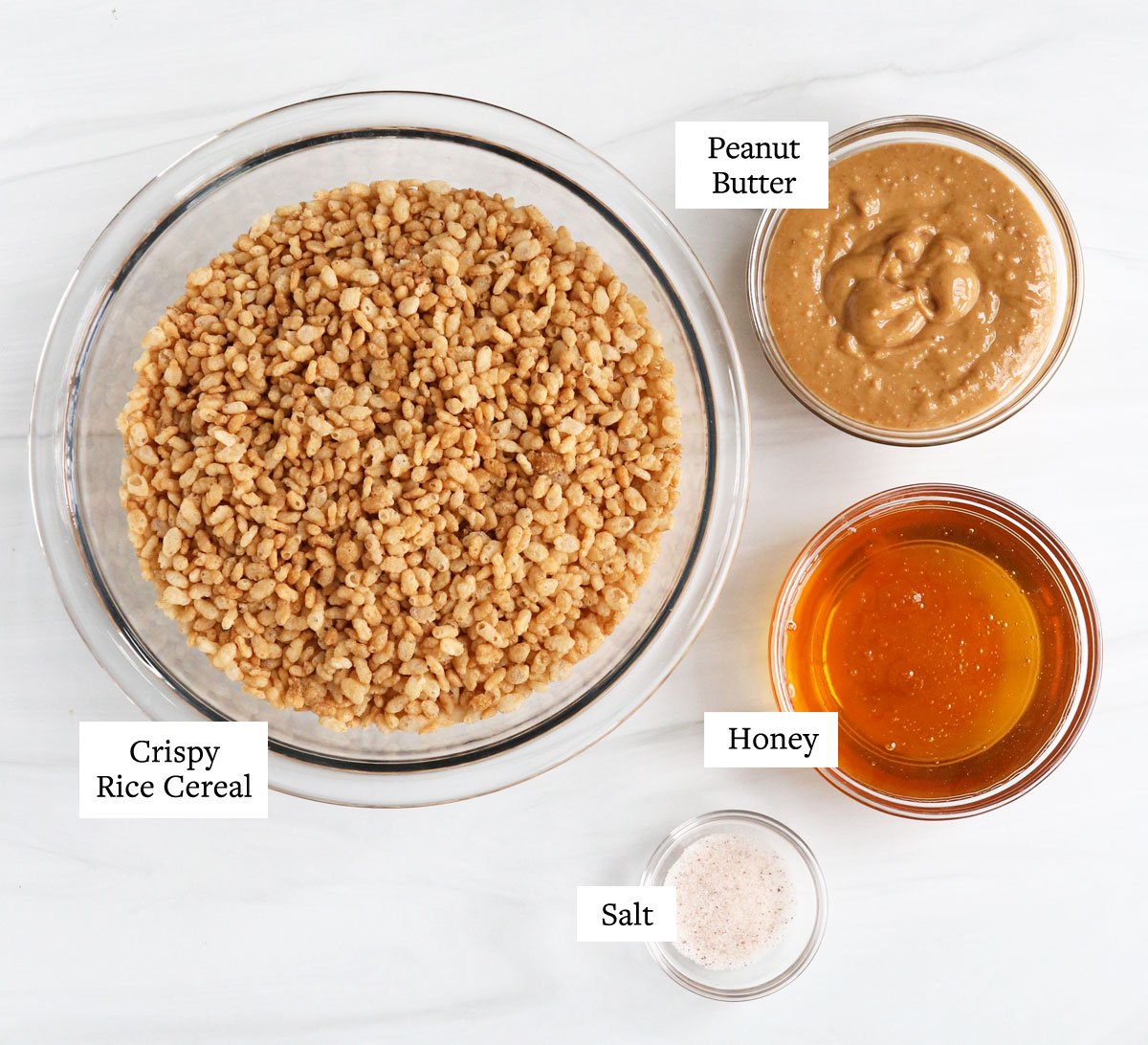 peanut butter rice crispy treat ingredients in glass bowls.