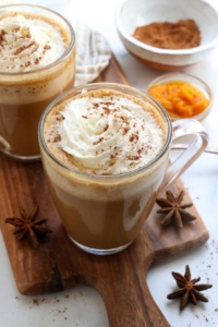 pumpkin spice latte in glass with whipped cream on top