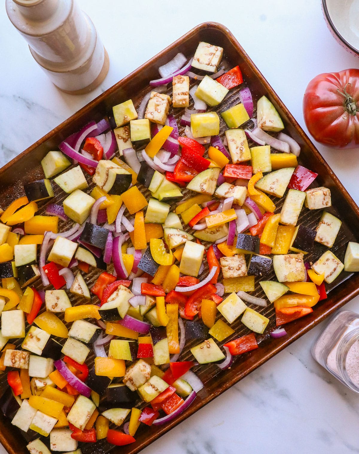 bell peppers, eggplant, and onion on a sheet pan.