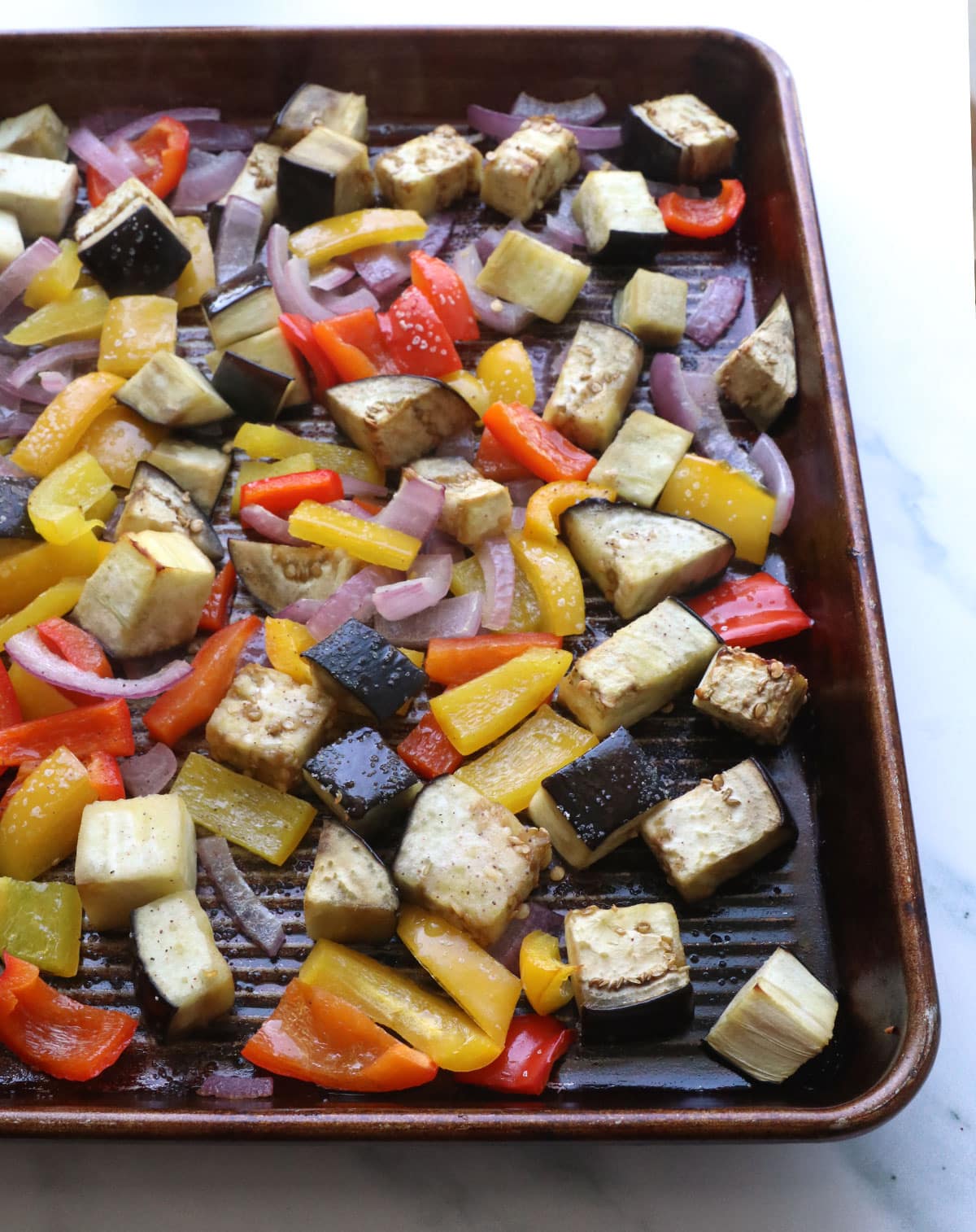 veggies after roasting in the oven on the sheet pan.