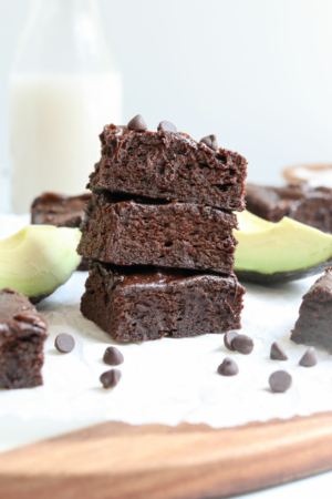 avocado brownies stacked on cutting board