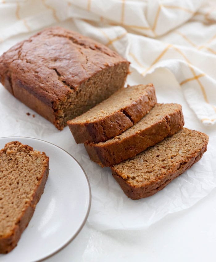 vegan banana bread sliced on a white surface