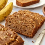vegan gluten free banana bread sliced on parchment paper.