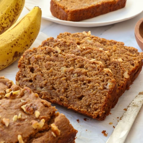vegan gluten free banana bread sliced on parchment paper.