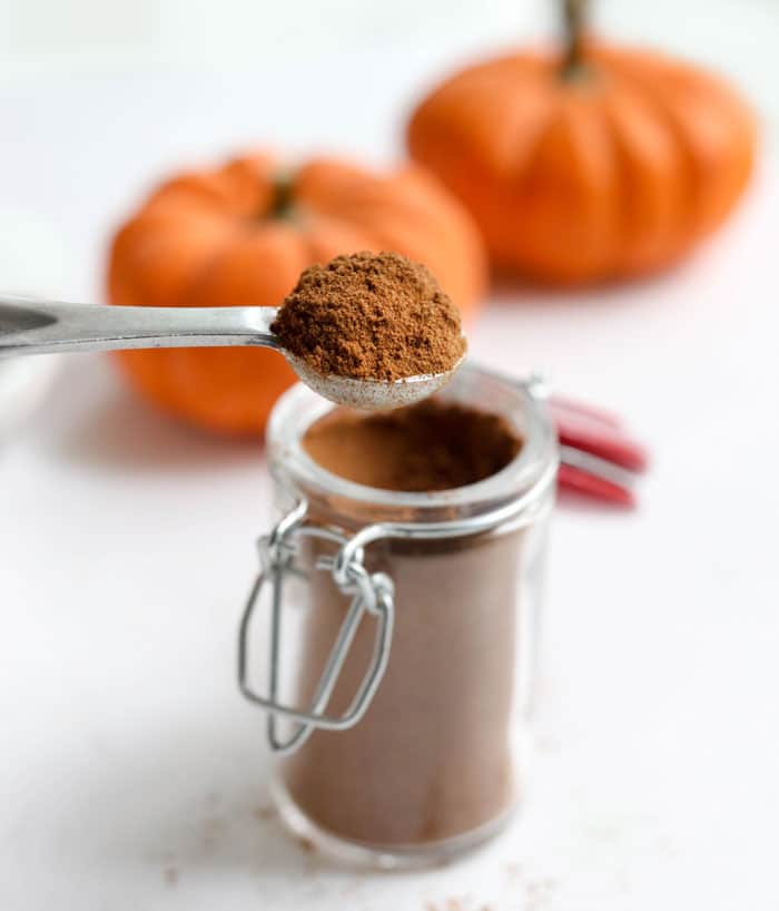 pumpkin pie spice with pumpkins in background