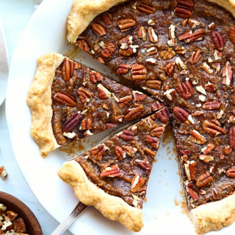 vegan pecan pie sliced in a pie plate.
