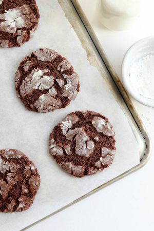 chocolate crinkle cookies on parchment paper