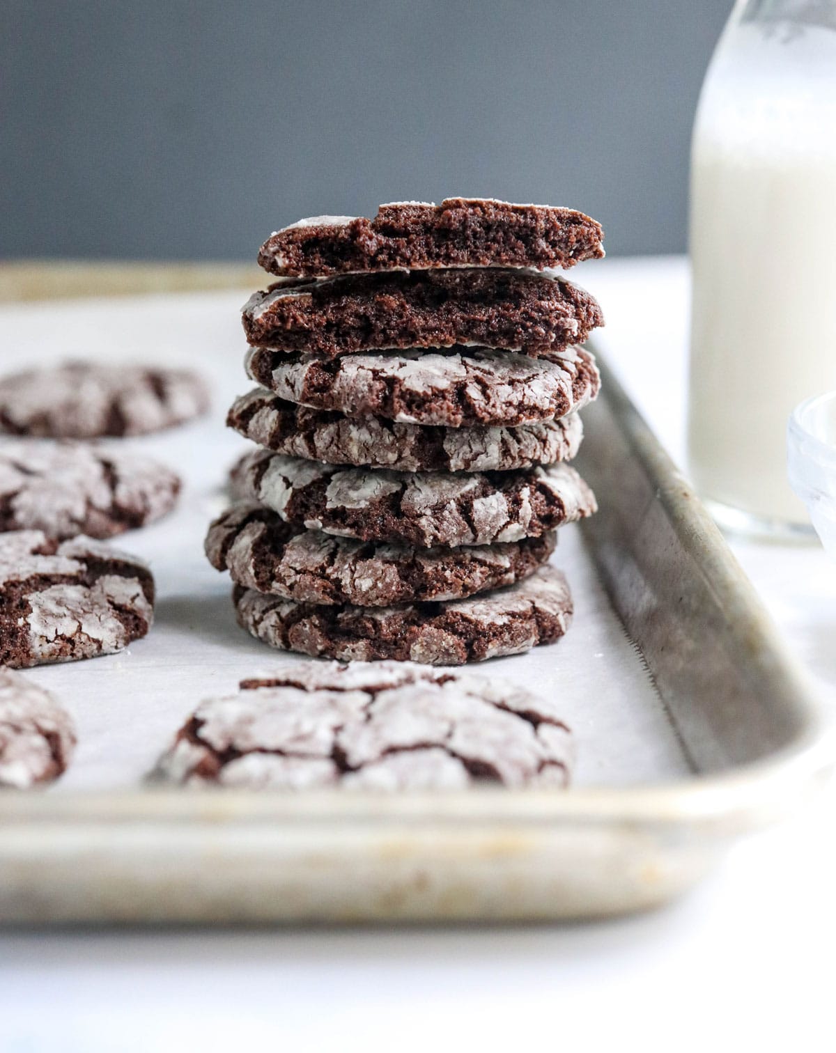 chocolate crinkle cookies stacked on pan