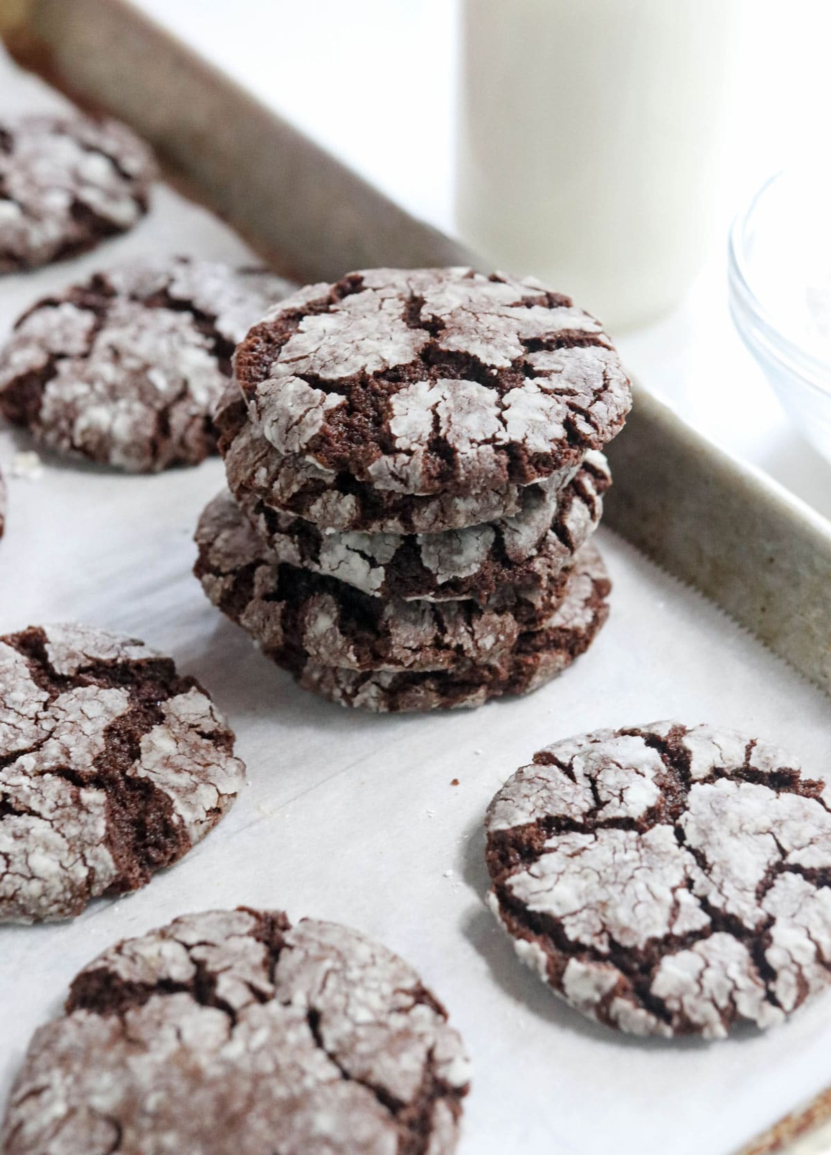 stack of chocolate cookies on a pan with milk