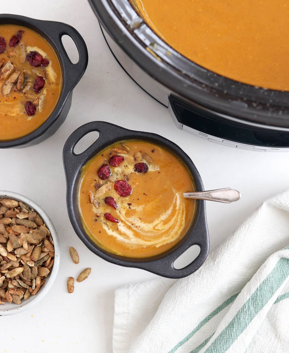 crockpot pumpkin soup in black bowls