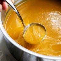 Butternut soup in a pot with a ladle