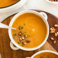 butternut squash soup served with roasted seeds on top.