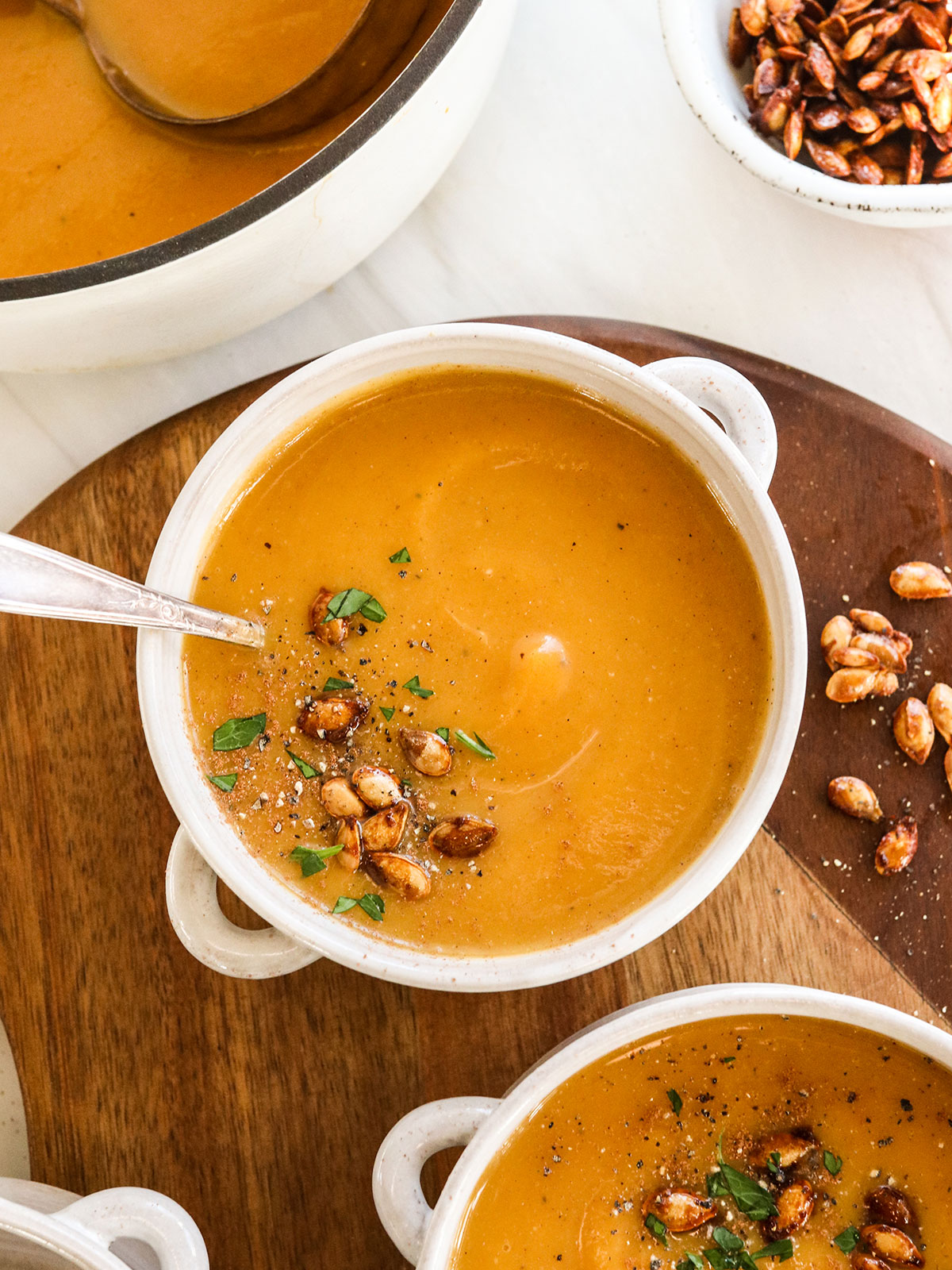 butternut squash soup served with roasted seeds on top.