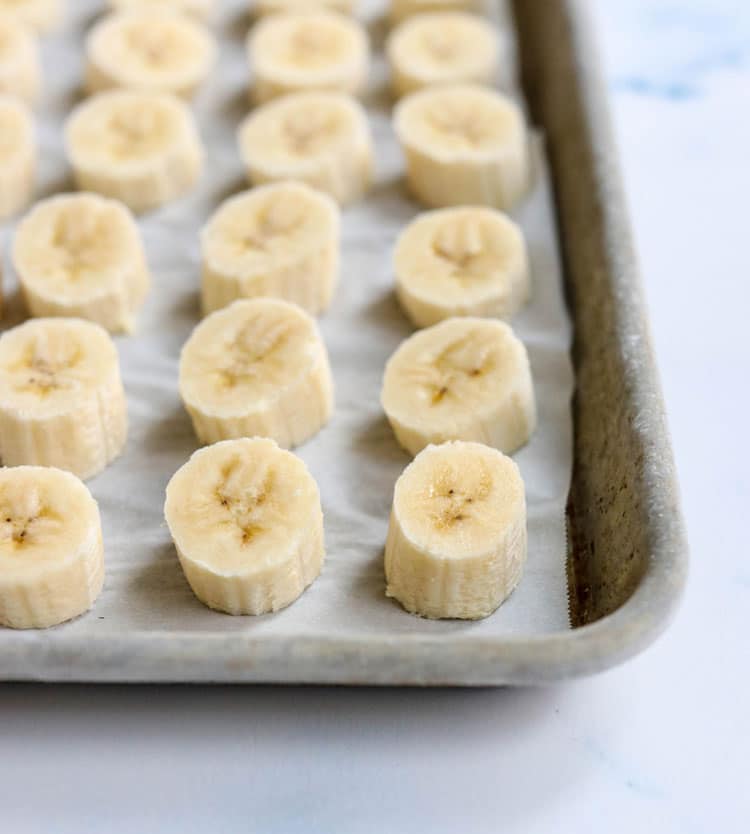 Frozen sliced bananas on a baking sheet