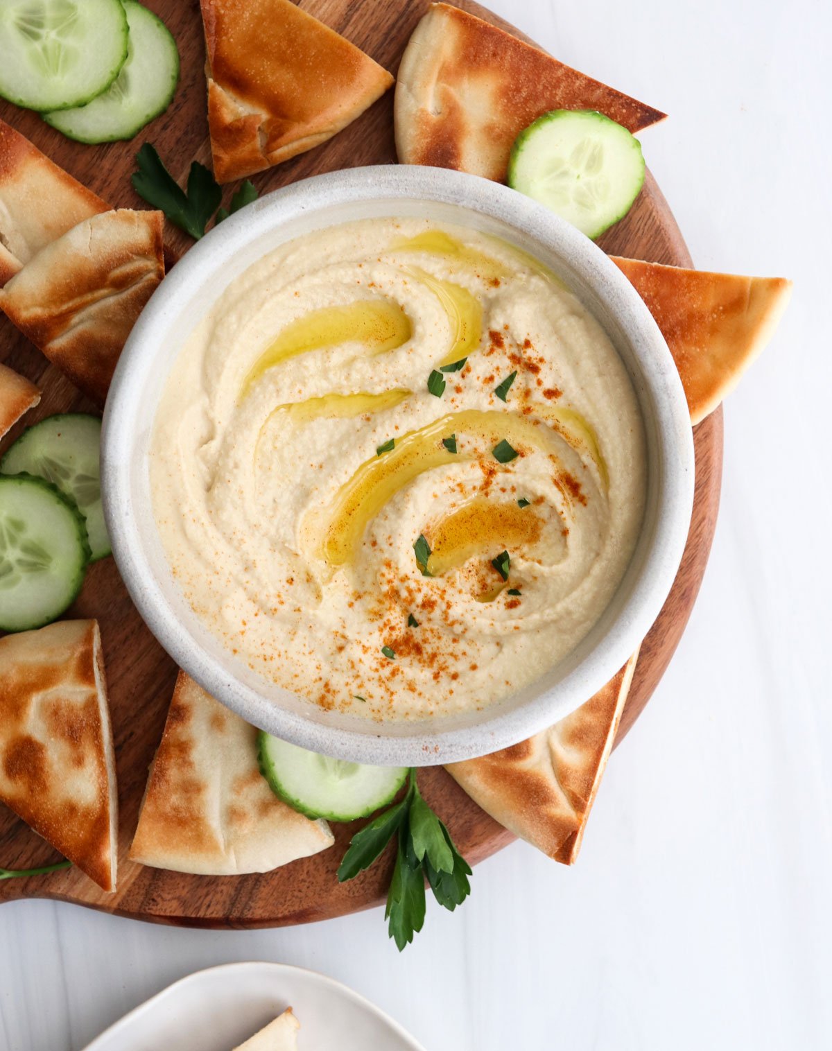 hummus served with pita bread and cucumbers.