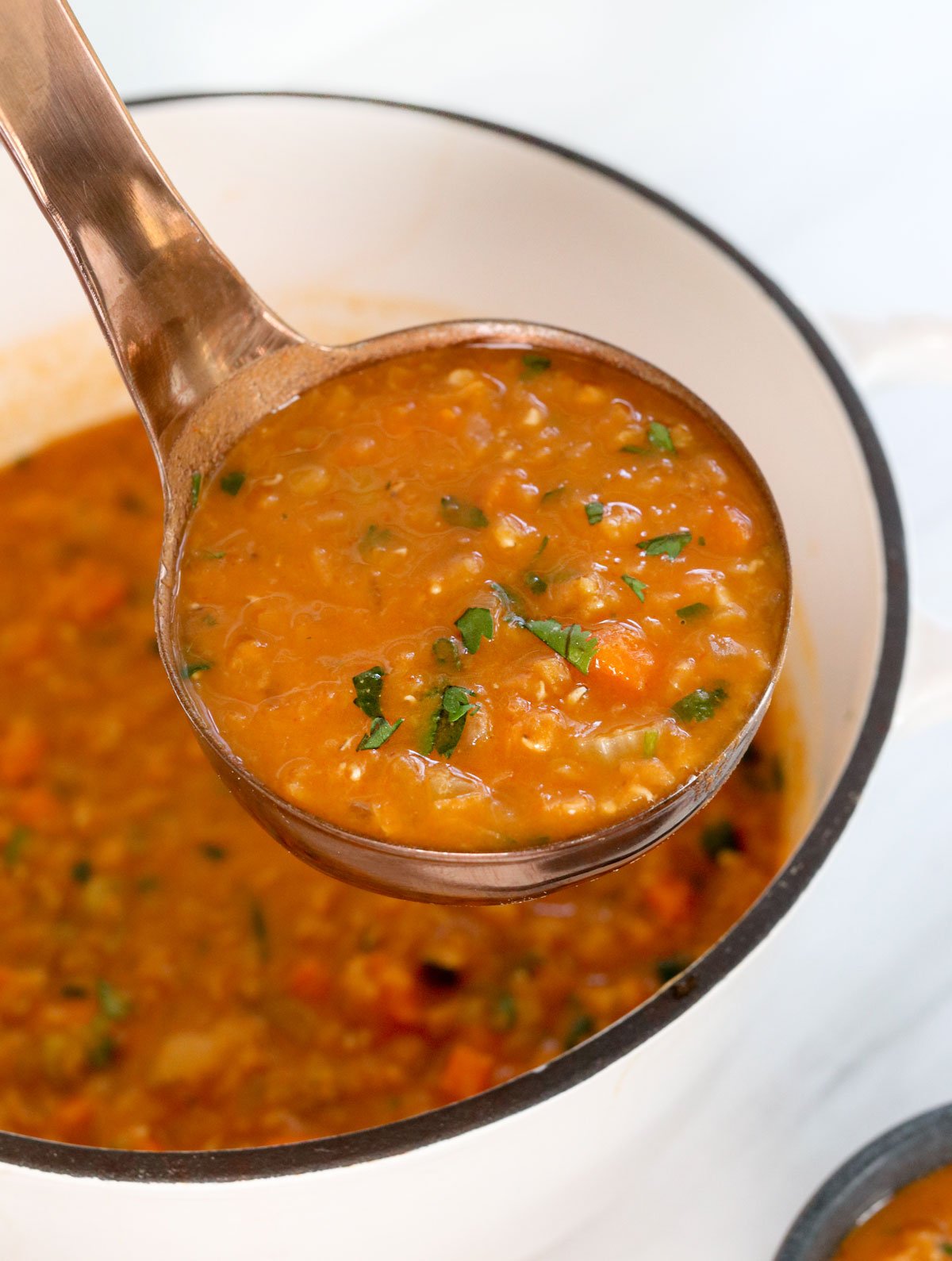 red lentil soup on ladle.