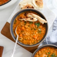 red lentil soup served with naan bread.