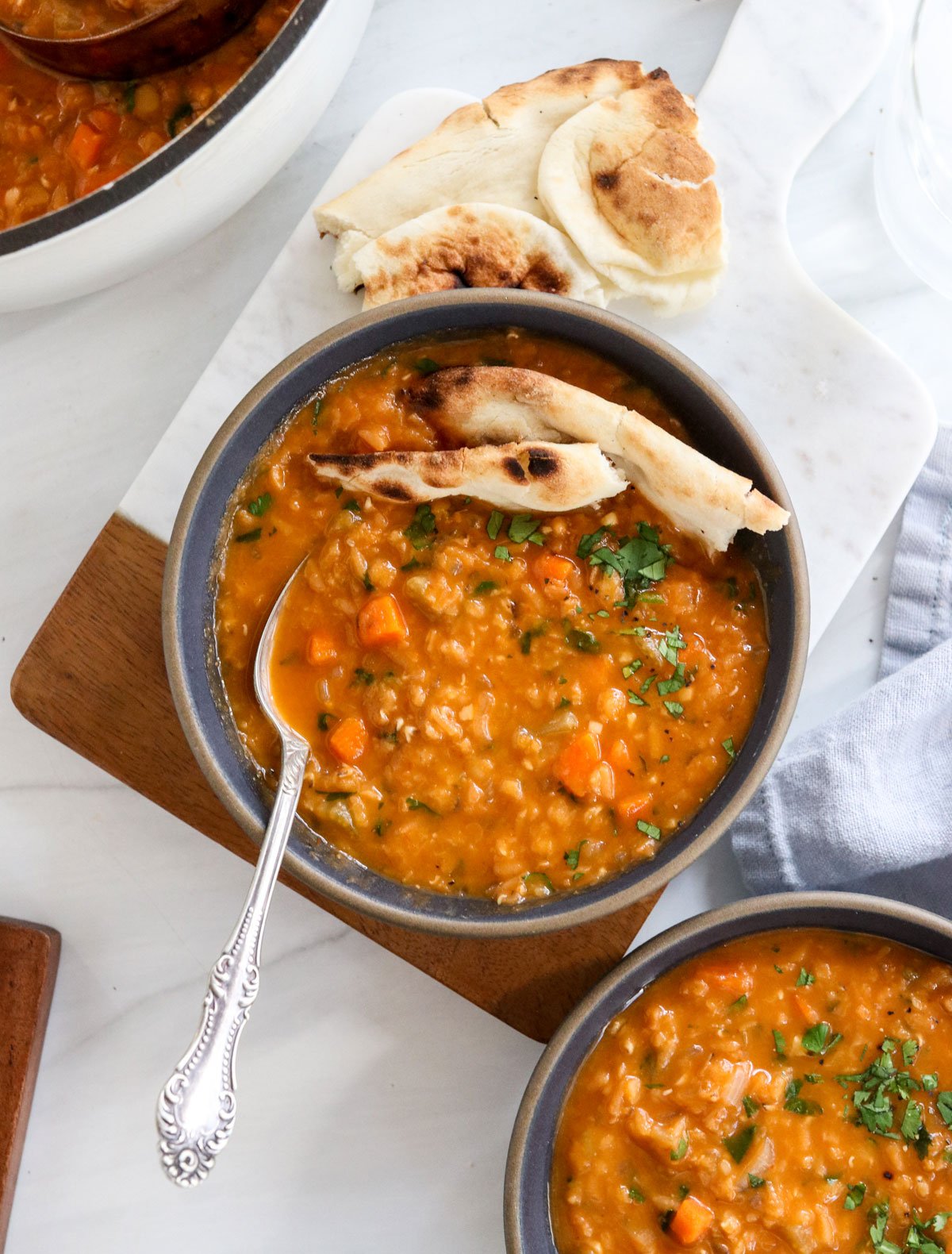 red lentil soup served with naan bread.