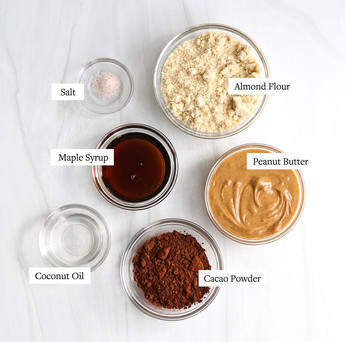 chocolate peanut butter bar ingredients labeled in glass bowls.