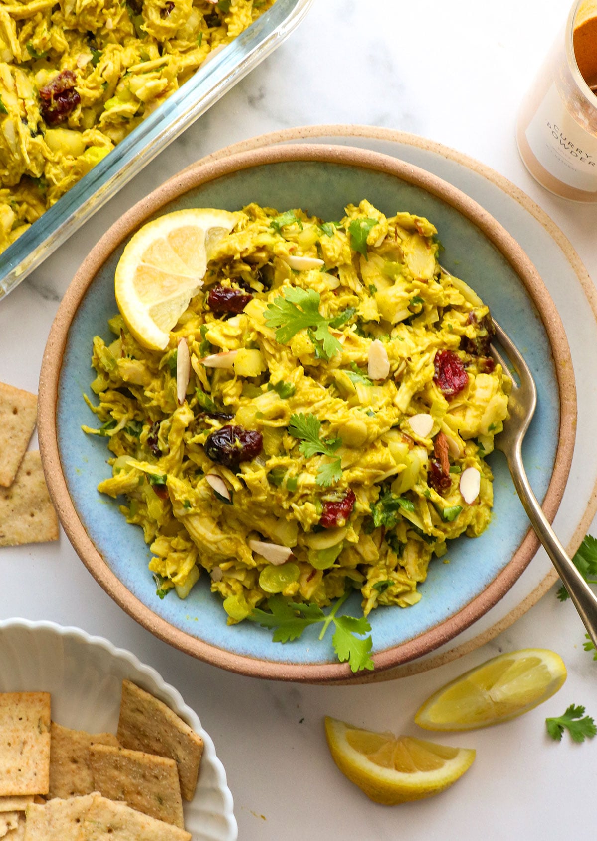 curried chicken salad made with avocado in a blue bowl.