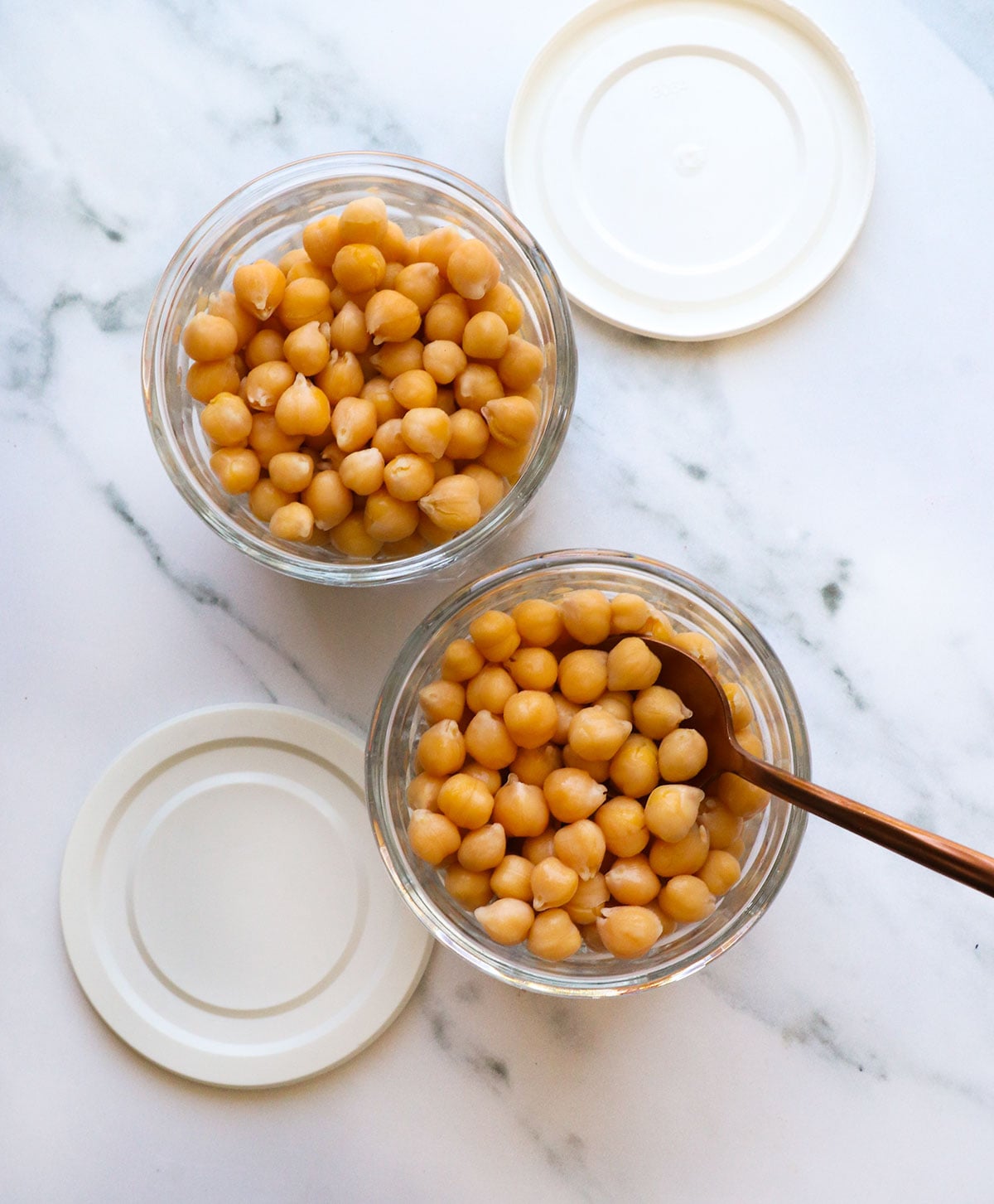 cooked chickpeas from scratch in two glass jars with lids.