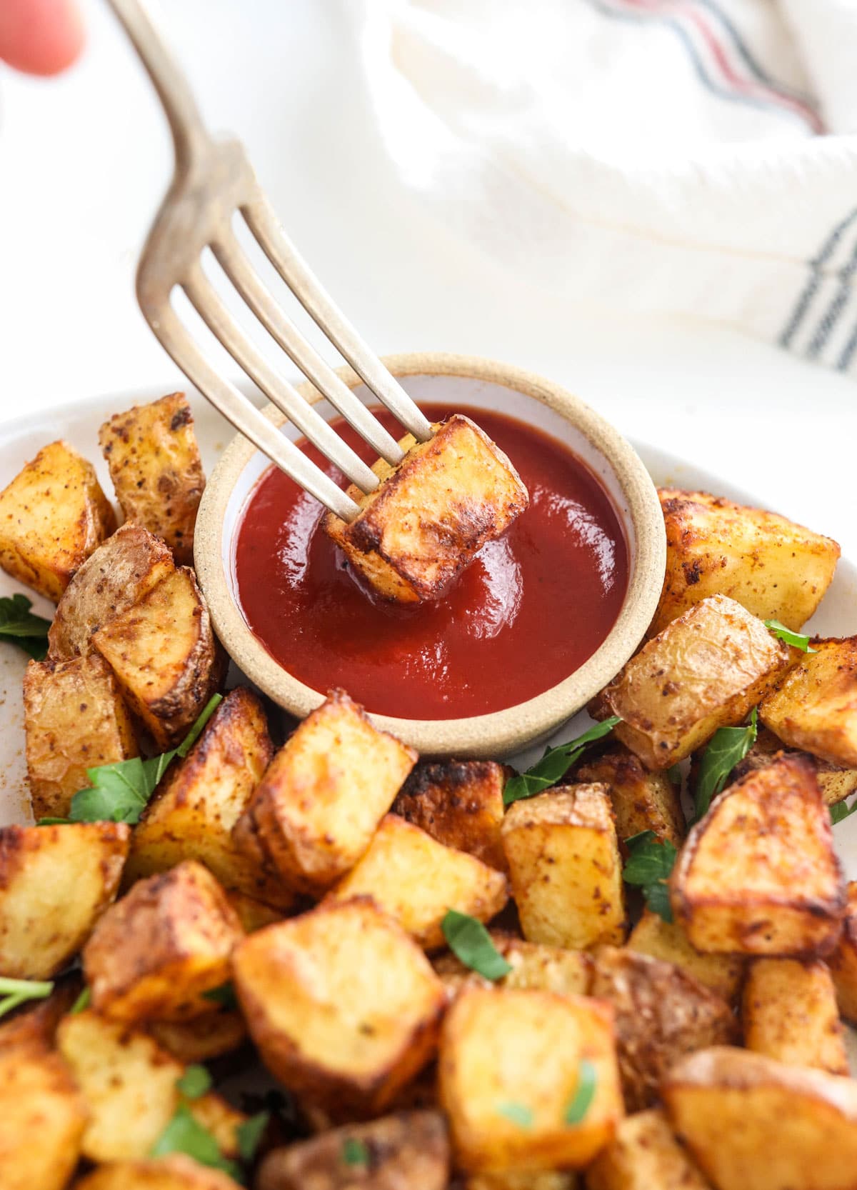 crispy potato on a fork in ketchup