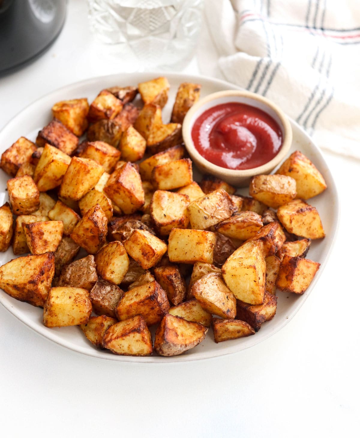 crispy air fryer potatoes on a plate with ketchup