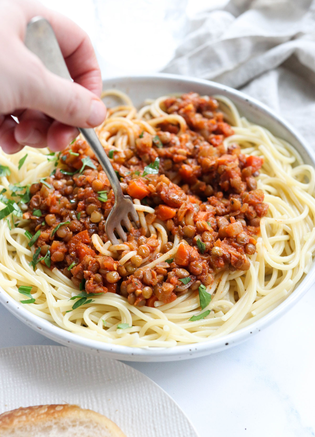 fork twirling lentil bolognese and spaghetti noodles
