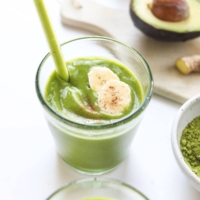 matcha smoothie in a glass with straw