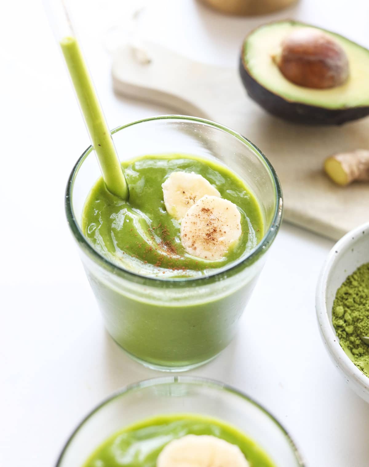 matcha smoothie in a glass with straw