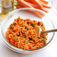 carrot salad in glass bowl with spatula