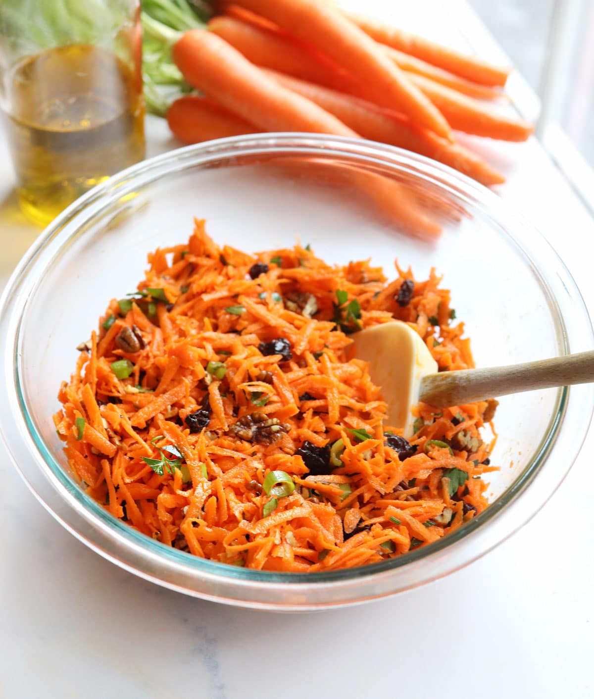 carrot salad in glass bowl with spatula