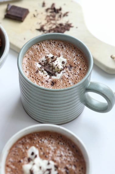date hot chocolate with coconut whipped cream and chocolate shavings