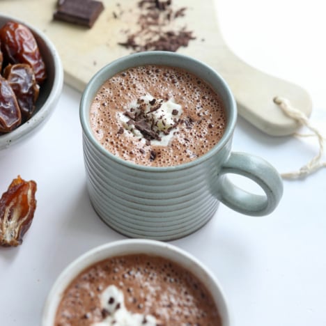 date hot chocolate with coconut whipped cream and chocolate shavings