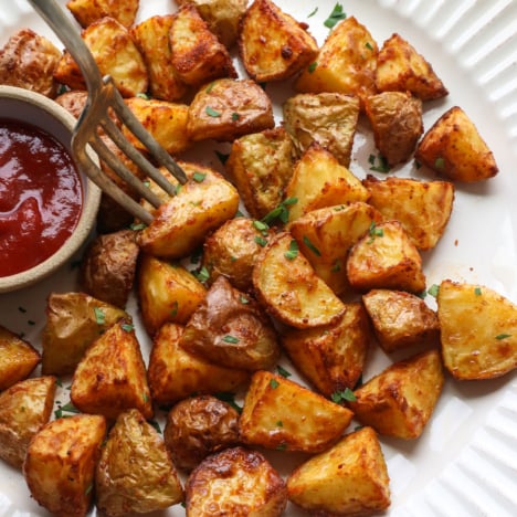 air fried potatoes on a white plate.