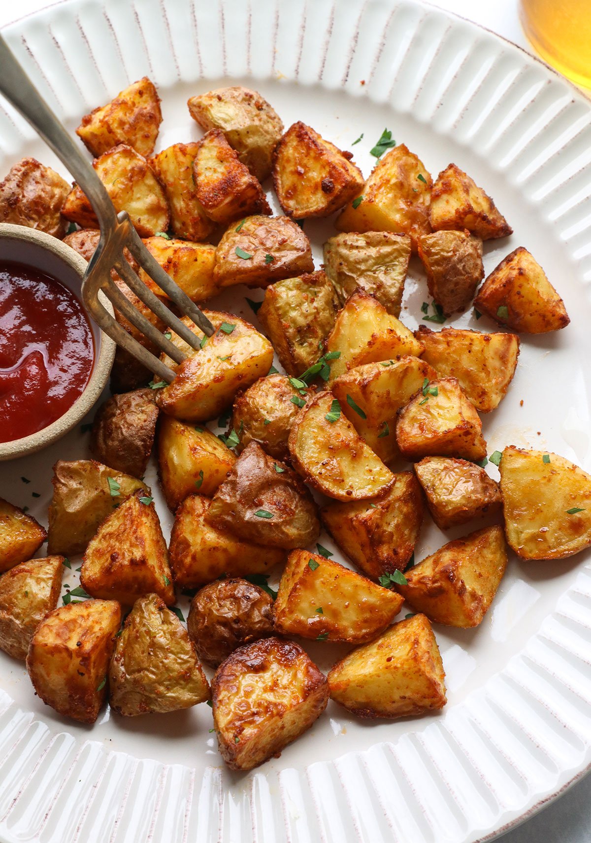 Fry potatoes on a white plate.