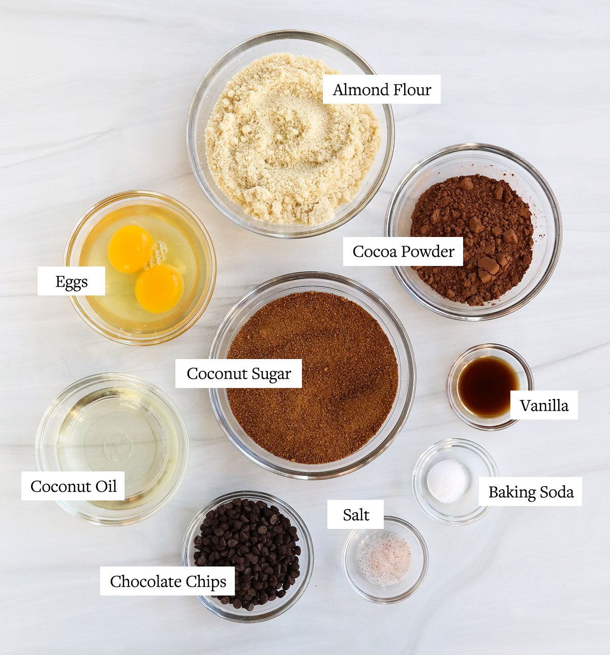 almond flour brownie ingredients labeled in glass bowls.