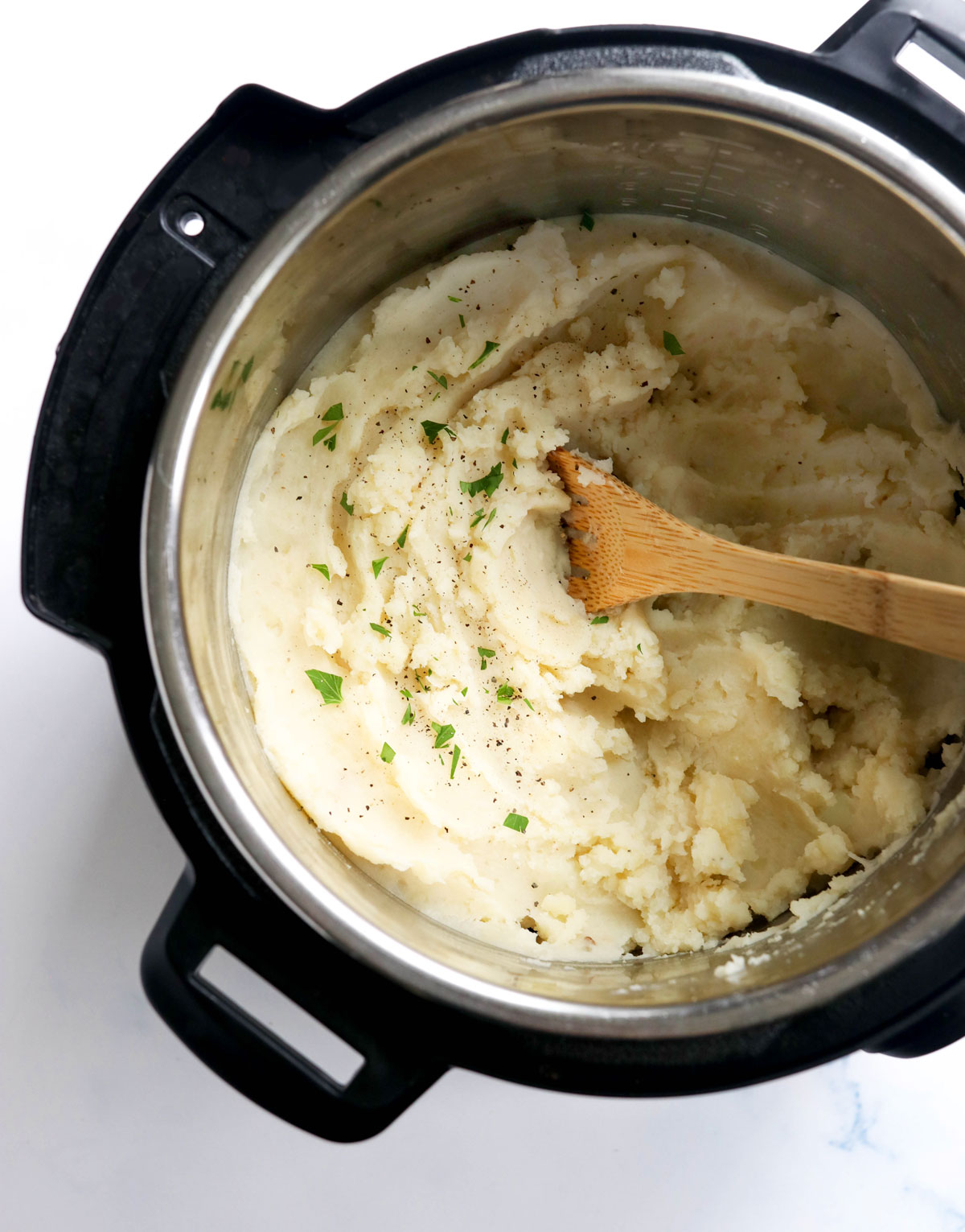 instant pot mashed potatoes with wooden spoon