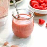 raspberry vinaigrette in glass jar with spoon.