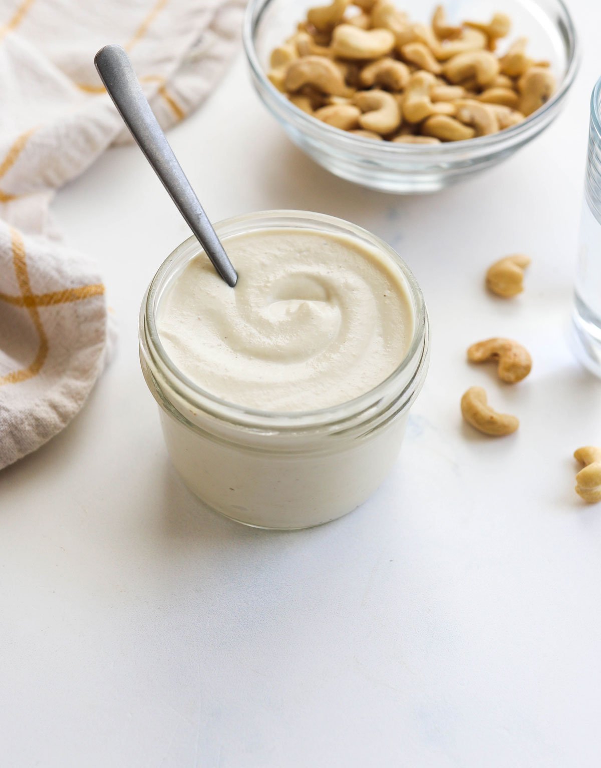 cashew cream in a glass jar with spoon